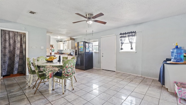 3814 Ripplebrook Dr, Houston, TX 77045 - dining room with a ceiling fan, a textured ceiling, and light tile patterned floors
