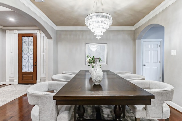 4706 Payton Chase Ln, Katy, TX 77494 - dining space featuring arched walkways, dark wood-style flooring, ornamental molding, baseboards, and a chandelier
