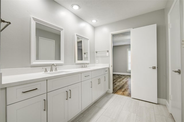 2706 Williams Grant St, Sugar Land, TX 77479 - bathroom featuring double vanity, baseboards, and recessed lighting