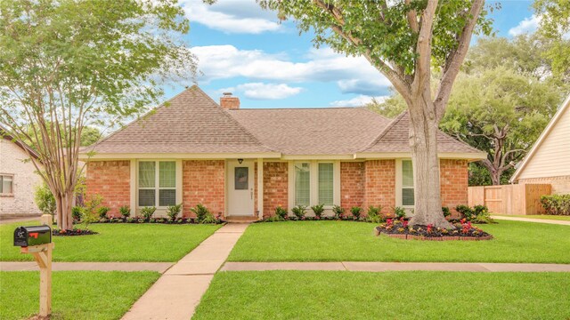 2706 Williams Grant St, Sugar Land, TX 77479 - view of front of home featuring roof with shingles, brick siding, and a chimney