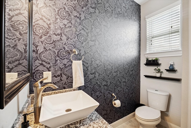 12226 Brighton Brook Ln, Tomball, TX 77377 - half bath with a sink, toilet, wallpapered walls, and baseboards