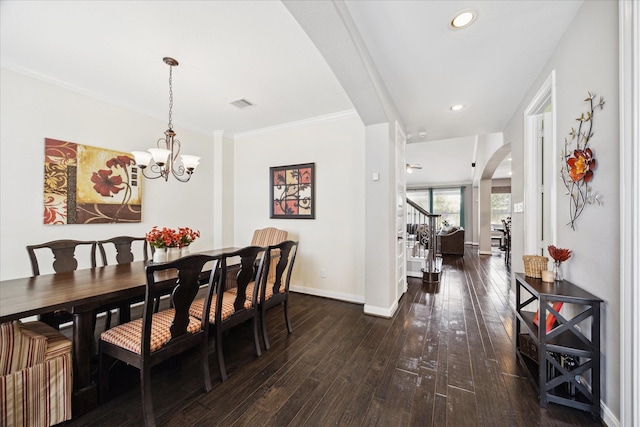 12226 Brighton Brook Ln, Tomball, TX 77377 - dining room with arched walkways, stairs, dark wood-style flooring, baseboards, and a chandelier