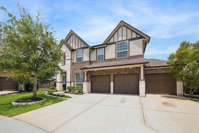 12226 Brighton Brook Ln, Tomball, TX 77377 - tudor home with concrete driveway, an attached garage, stone siding, roof with shingles, and a front lawn