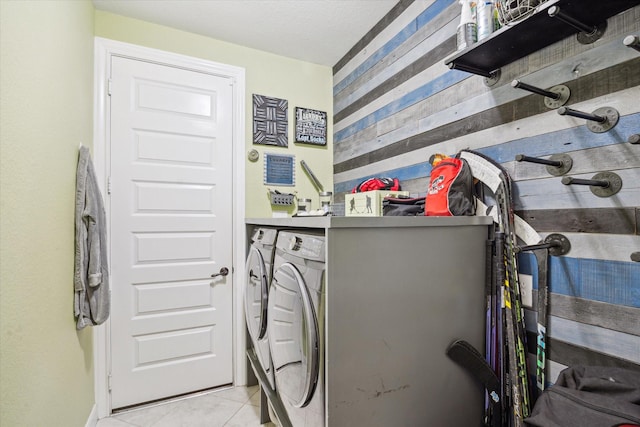12226 Brighton Brook Ln, Tomball, TX 77377 - laundry area with separate washer and dryer, light tile patterned flooring, and wood walls