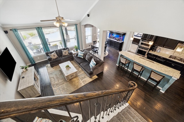 12226 Brighton Brook Ln, Tomball, TX 77377 - living area with arched walkways, ornamental molding, wood-type flooring, a ceiling fan, and baseboards