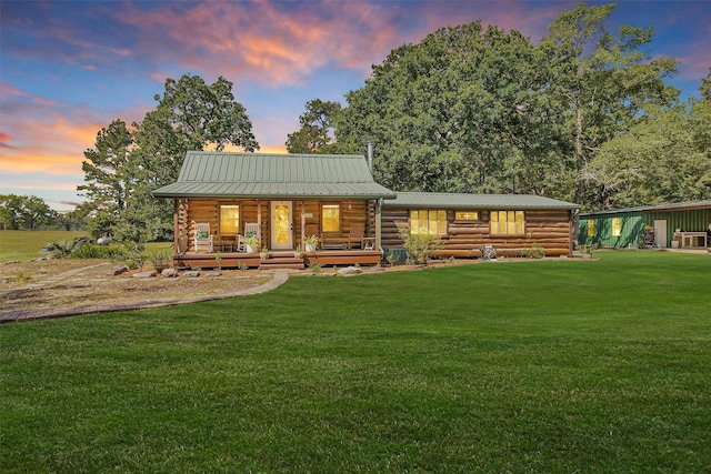 1356 Pegoda Ranch Rd, Woodlake, TX 75865 - view of front facade featuring log siding, a porch, a front lawn, and metal roof