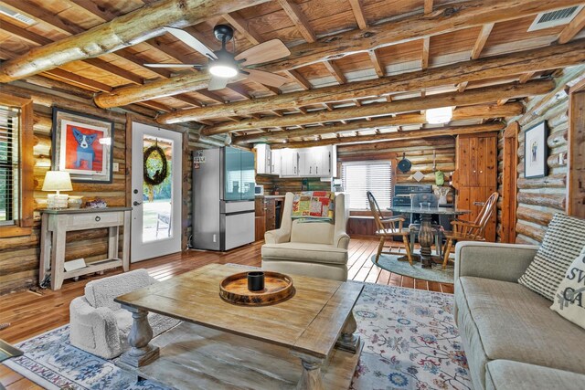 1356 Pegoda Ranch Rd, Woodlake, TX 75865 - living room with log walls, a ceiling fan, wooden ceiling with exposed beams, and light wood-style floors
