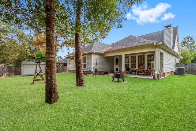143 Jacks Corner Dr, Montgomery, TX 77316 - rear view of house with central AC unit, a patio area, a chimney, and a shingled roof
