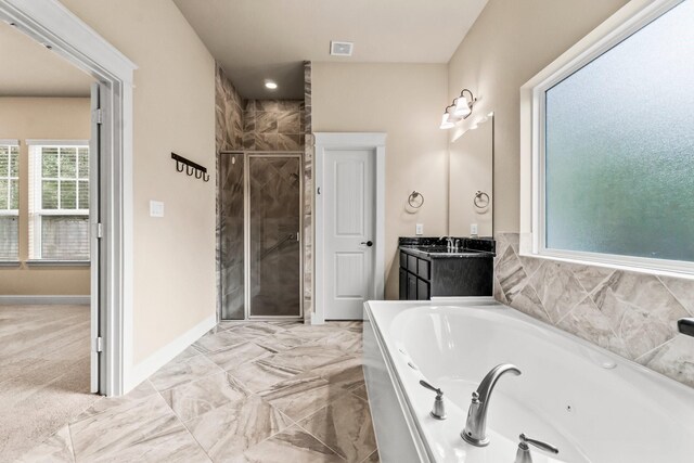 143 Jacks Corner Dr, Montgomery, TX 77316 - bathroom with a stall shower, a tub with jets, vanity, and baseboards