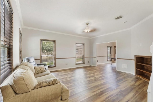 4910 Bayfair St, Pasadena, TX 77505 - living room featuring healthy amount of natural light, wood finished floors, and ornamental molding