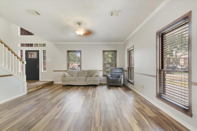 4910 Bayfair St, Pasadena, TX 77505 - living room with wood finished floors, stairs, and crown molding