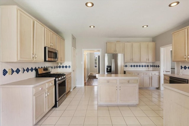 4910 Bayfair St, Pasadena, TX 77505 - kitchen with appliances with stainless steel finishes, tasteful backsplash, light brown cabinets, a kitchen island, and light countertops