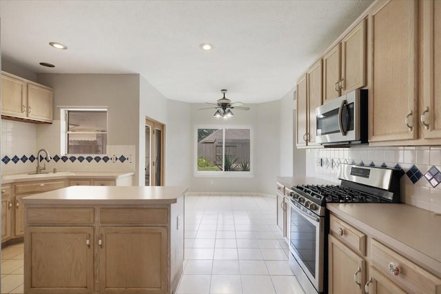 4910 Bayfair St, Pasadena, TX 77505 - kitchen featuring appliances with stainless steel finishes, light brown cabinets, light tile patterned floors, tasteful backsplash, and ceiling fan