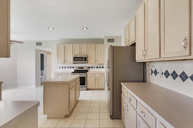 4910 Bayfair St, Pasadena, TX 77505 - kitchen with appliances with stainless steel finishes, light brown cabinets, backsplash, recessed lighting, and a kitchen island