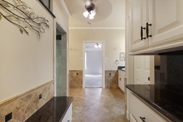 4910 Bayfair St, Pasadena, TX 77505 - bathroom with tile walls, ceiling fan, vanity, crown molding, and wainscoting