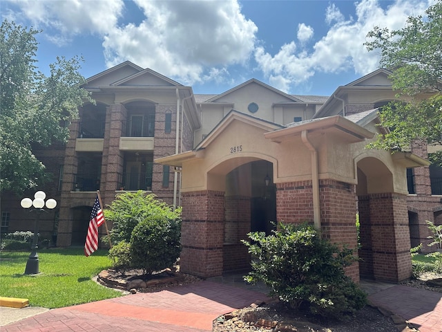 2815 Kings Crossing Dr Unit 308, Houston, TX 77345 - view of front of house with brick siding and stucco siding