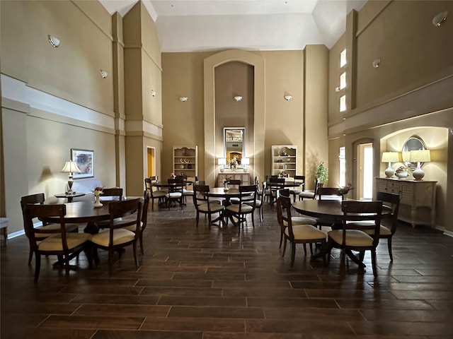 2815 Kings Crossing Dr Unit 308, Houston, TX 77345 - dining space with a towering ceiling, dark wood finished floors, healthy amount of natural light, and arched walkways