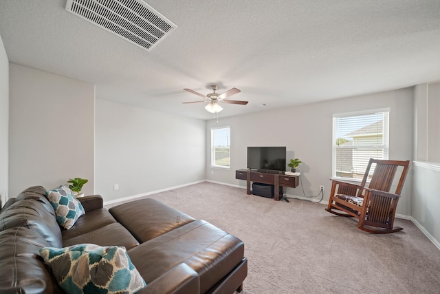 7410 Arabian Moon Trl, Fulshear, TX 77441 - carpeted living room with ceiling fan, baseboards, and a textured ceiling