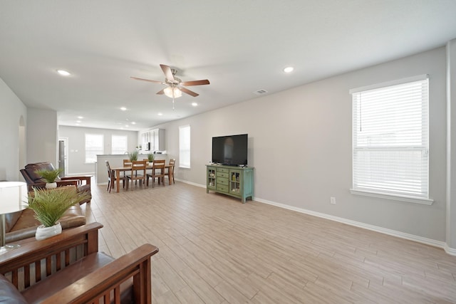 7410 Arabian Moon Trl, Fulshear, TX 77441 - living area featuring a ceiling fan, recessed lighting, light wood-style flooring, and baseboards