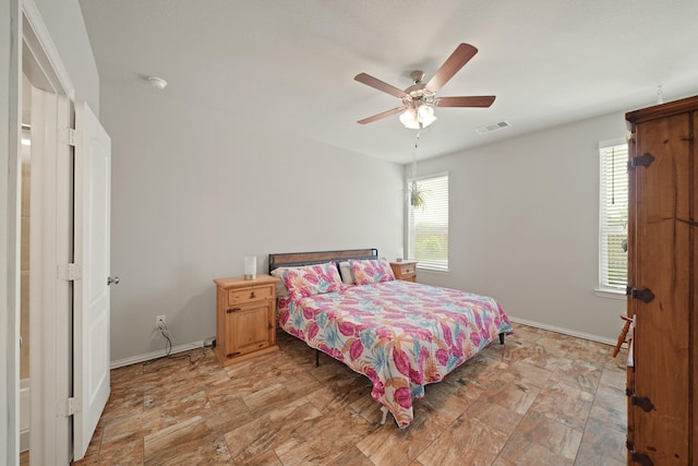 7410 Arabian Moon Trl, Fulshear, TX 77441 - bedroom featuring multiple windows, a ceiling fan, and baseboards