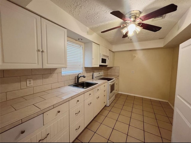 16307 Thistleglen Dr, Houston, TX 77095 - kitchen with white appliances, a sink, tile counters, a textured ceiling, and tasteful backsplash