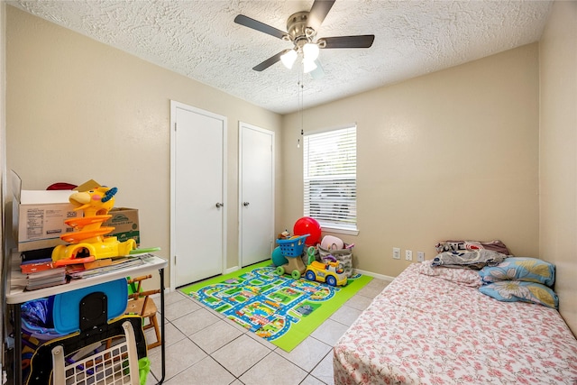 16307 Thistleglen Dr, Houston, TX 77095 - bedroom featuring a textured ceiling, light tile patterned floors, and ceiling fan
