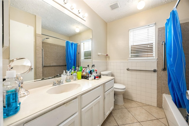 16307 Thistleglen Dr, Houston, TX 77095 - full bath with vanity, tile patterned floors, toilet, tile walls, and shower / bath combo