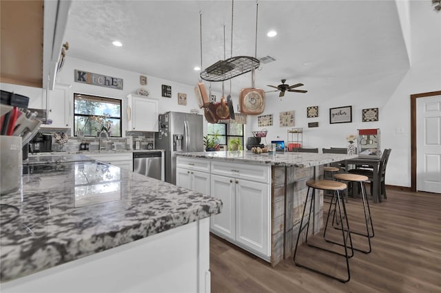 711 Forest Spgs, Livingston, TX 77351 - kitchen featuring appliances with stainless steel finishes, plenty of natural light, white cabinetry, and recessed lighting