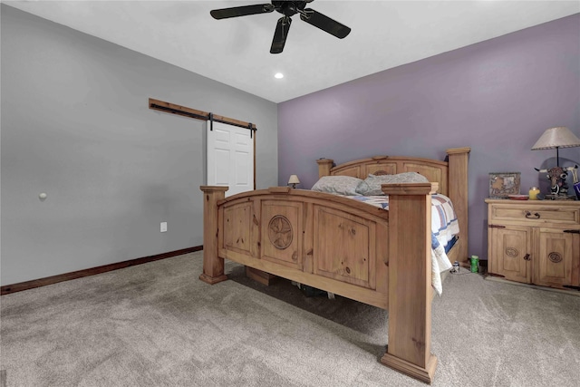 711 Forest Spgs, Livingston, TX 77351 - bedroom with a barn door, light carpet, a ceiling fan, and baseboards