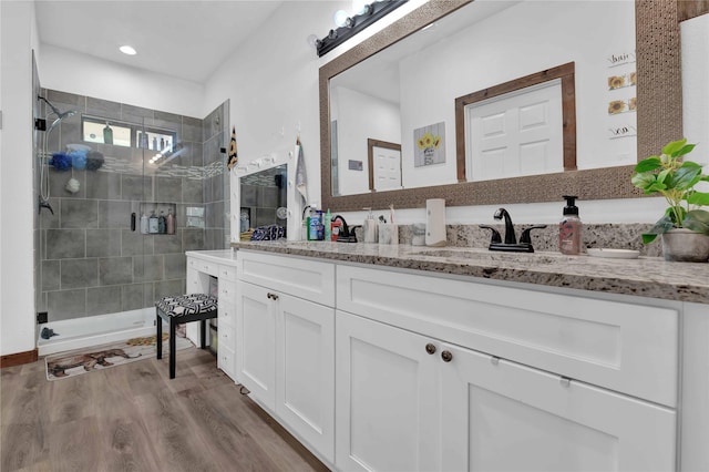 711 Forest Spgs, Livingston, TX 77351 - bathroom with double vanity, a shower stall, and wood finished floors
