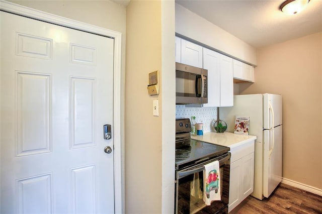 10075 Westpark Dr Unit 45, Houston, TX 77042 - kitchen featuring stainless steel microwave, black / electric stove, dark wood finished floors, white cabinets, and light countertops