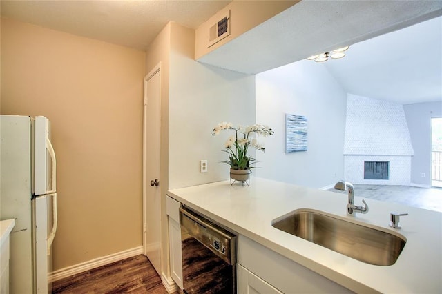 10075 Westpark Dr Unit 45, Houston, TX 77042 - kitchen featuring freestanding refrigerator, a sink, dishwasher, dark wood finished floors, and light countertops