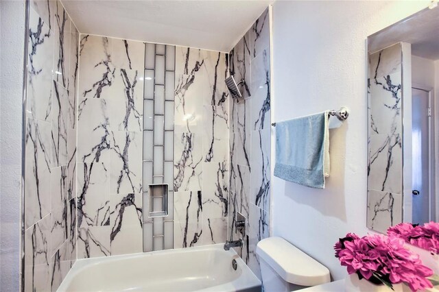 10075 Westpark Dr Unit 45, Houston, TX 77042 - bathroom featuring toilet and shower / washtub combination