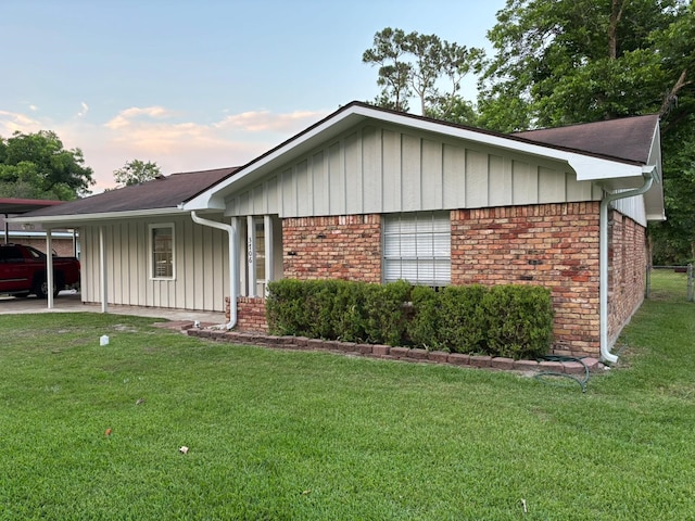 3706 Galway Ln, Houston, TX 77080 - ranch-style house with board and batten siding, a front yard, brick siding, and a carport