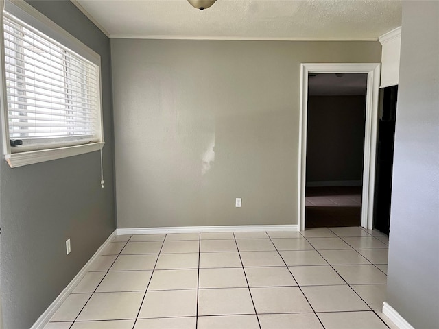 3134 7th Ave N, Texas City, TX 77590 - spare room with light tile patterned flooring, baseboards, and crown molding