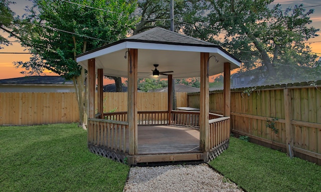 5313 De Lange Ln, Houston, TX 77092 - deck at dusk with a gazebo, ceiling fan, and a fenced backyard