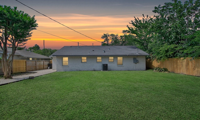 5313 De Lange Ln, Houston, TX 77092 - back of house at dusk featuring brick siding and central air condition unit