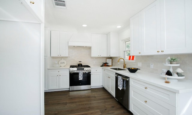 5313 De Lange Ln, Houston, TX 77092 - kitchen with stainless steel gas range oven, dishwashing machine, premium range hood, backsplash, and recessed lighting