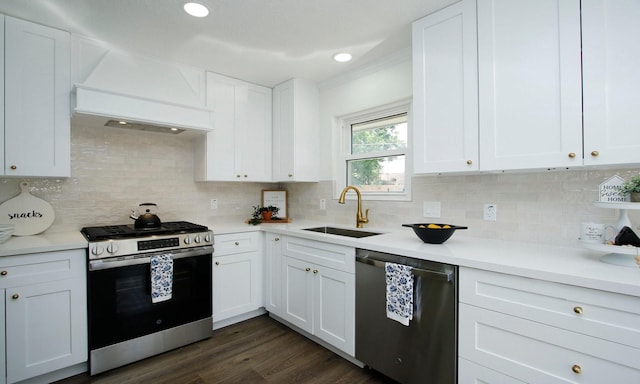 5313 De Lange Ln, Houston, TX 77092 - kitchen featuring stainless steel appliances, a sink, custom range hood, light countertops, and white cabinetry