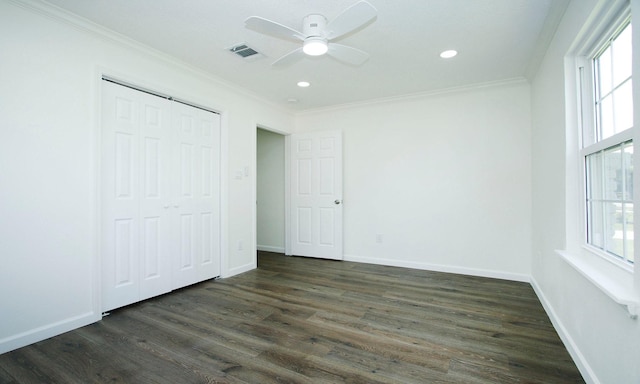 5313 De Lange Ln, Houston, TX 77092 - unfurnished bedroom featuring ornamental molding, dark wood finished floors, multiple windows, recessed lighting, and a closet
