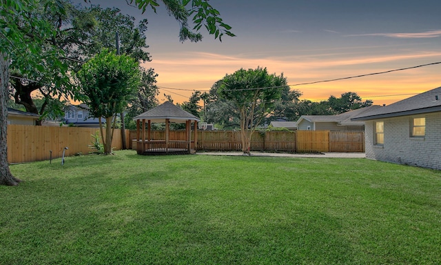 5313 De Lange Ln, Houston, TX 77092 - yard at dusk with a gazebo and a fenced backyard