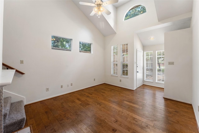 5515 Strack Rd Unit 101, Houston, TX 77069 - unfurnished living room with a high ceiling, wood-type flooring, stairs, ceiling fan, and baseboards