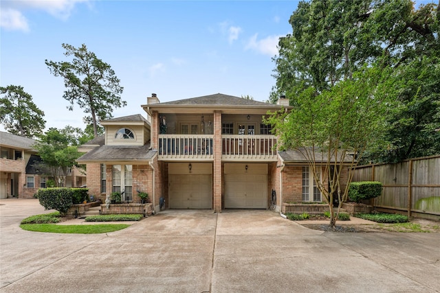 5515 Strack Rd Unit 101, Houston, TX 77069 - view of front of property featuring a chimney, a balcony, driveway, and a garage