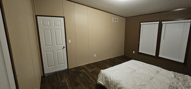 114 Dolphin Hbr N, Baytown, TX 77523 - bedroom with dark wood-type flooring, baseboards, vaulted ceiling, crown molding, and a textured ceiling