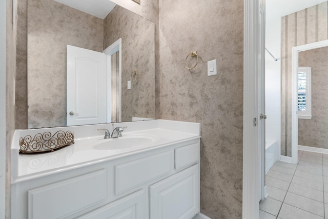 12027 Water Oak Dr, Magnolia, TX 77354 - full bathroom featuring vanity, tile patterned floors, wallpapered walls, baseboards, and shower / bath combination