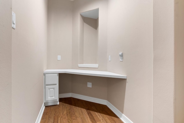 12027 Water Oak Dr, Magnolia, TX 77354 - unfurnished office featuring built in desk, wood finished floors, and baseboards