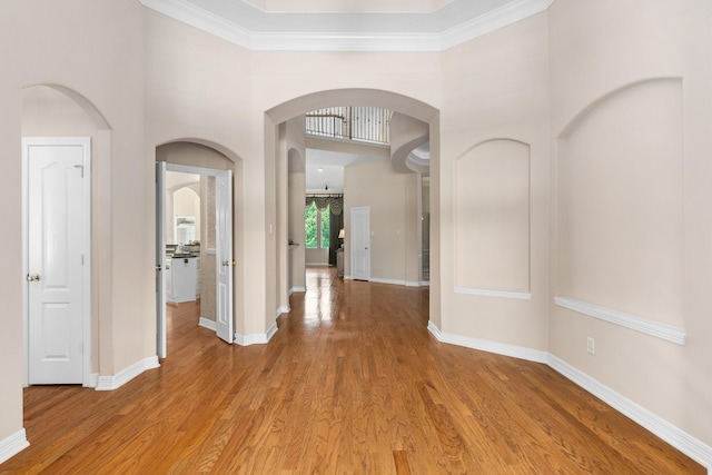 12027 Water Oak Dr, Magnolia, TX 77354 - foyer featuring arched walkways, light wood-type flooring, baseboards, ornamental molding, and a high ceiling