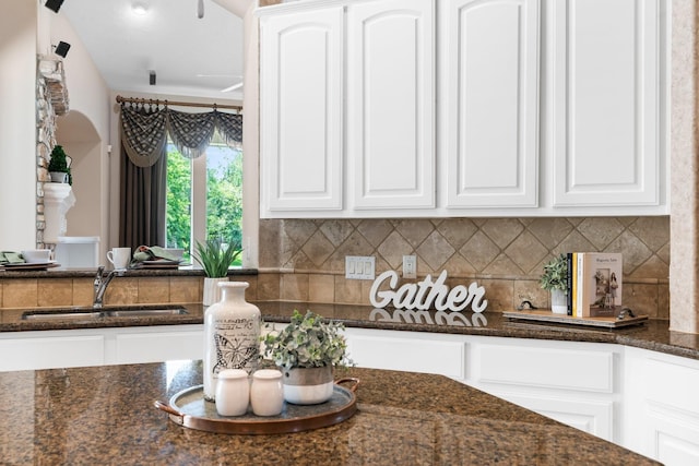 12027 Water Oak Dr, Magnolia, TX 77354 - kitchen with a sink, white cabinetry, dark stone counters, and decorative backsplash