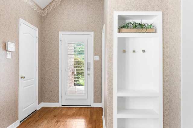 12027 Water Oak Dr, Magnolia, TX 77354 - mudroom featuring wood finished floors, wallpapered walls, built in shelves, and baseboards