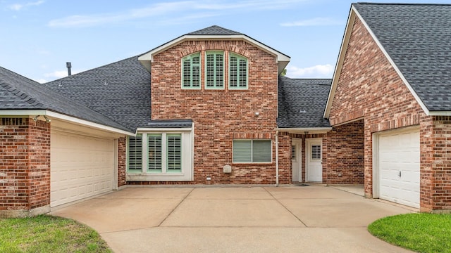 12027 Water Oak Dr, Magnolia, TX 77354 - traditional-style house featuring an attached garage, driveway, brick siding, and roof with shingles